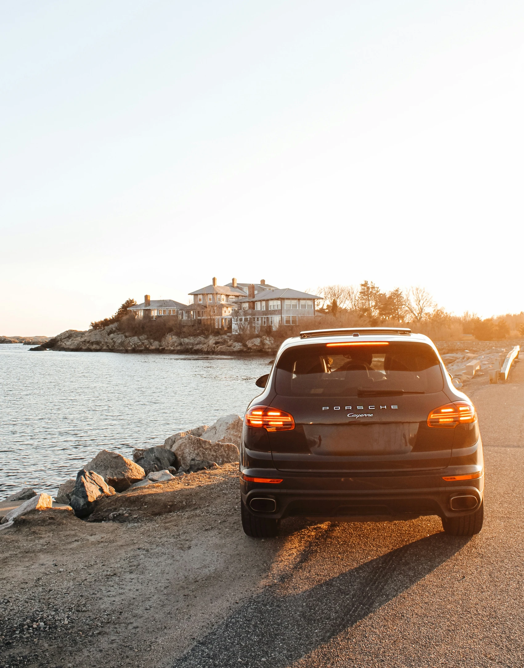 the car is parked along a body of water