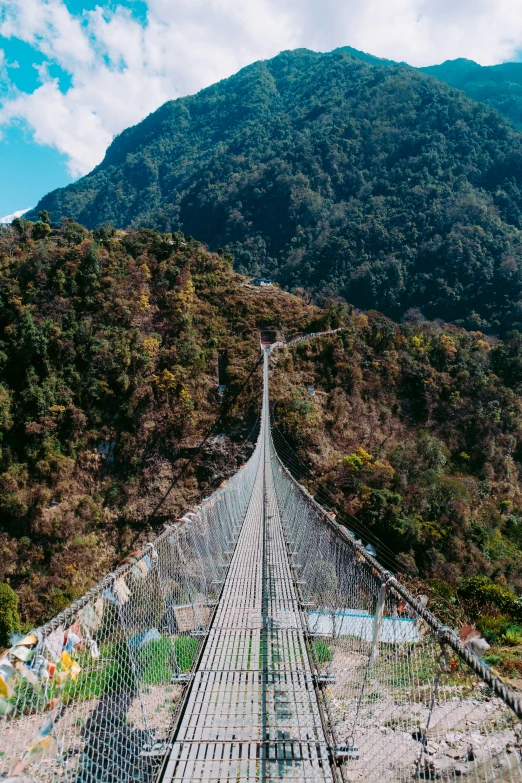 a very long metal walkway in a mountain area