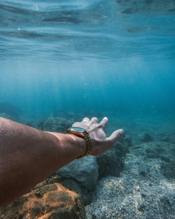 a man holding his hand in the water