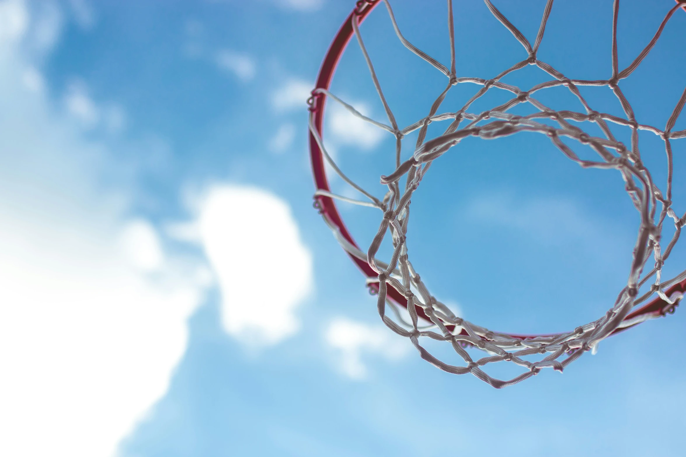 a basketball hoop with no net on a sunny day