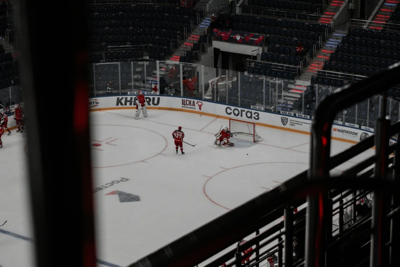 an indoor rink with hockey players and fans