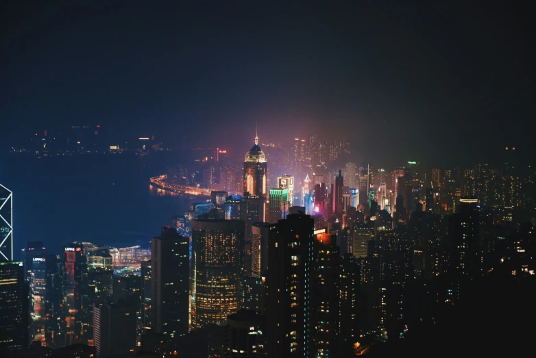 the skyline of hong kong is lit up at night