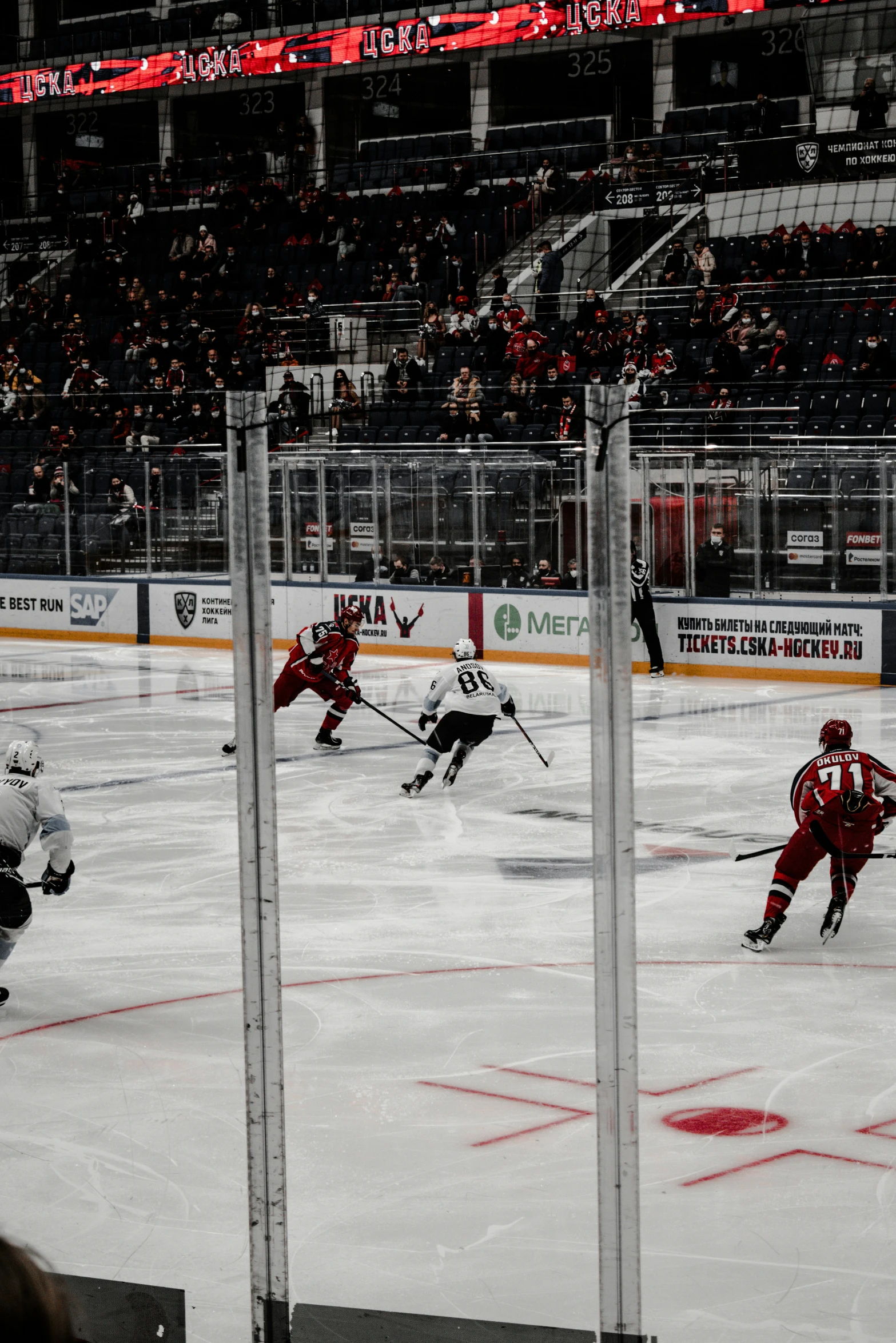 hockey players are playing in an arena on the ice