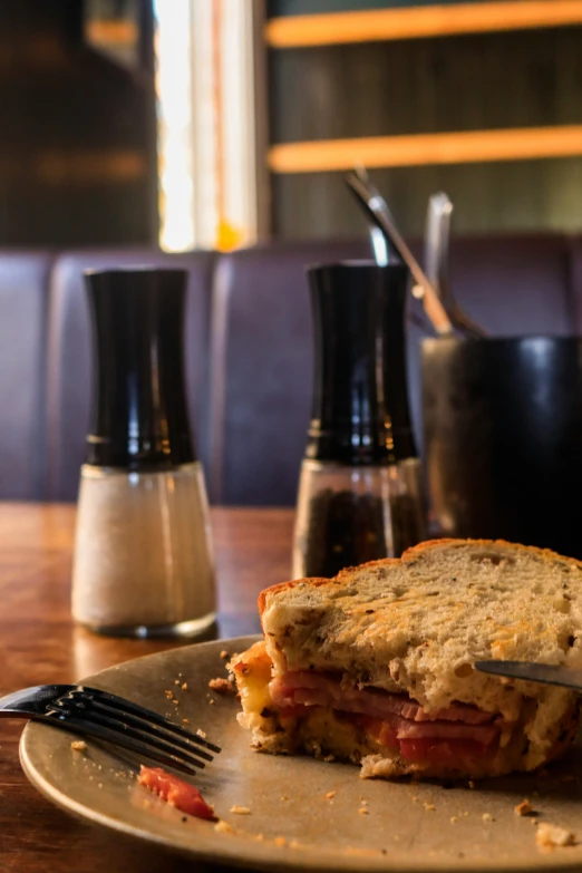 a piece of toasted bread sitting on top of a plate next to a knife and fork