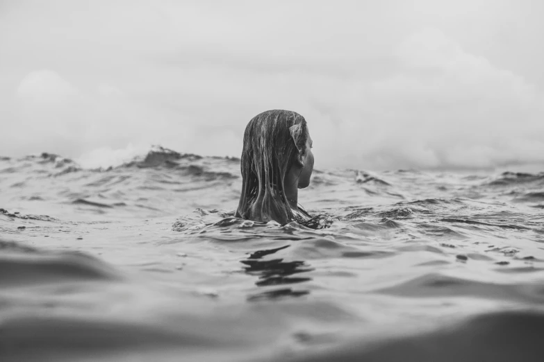 a person in the water holding soing up to their head