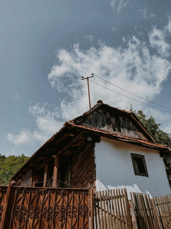 an old house with a wooden gate outside