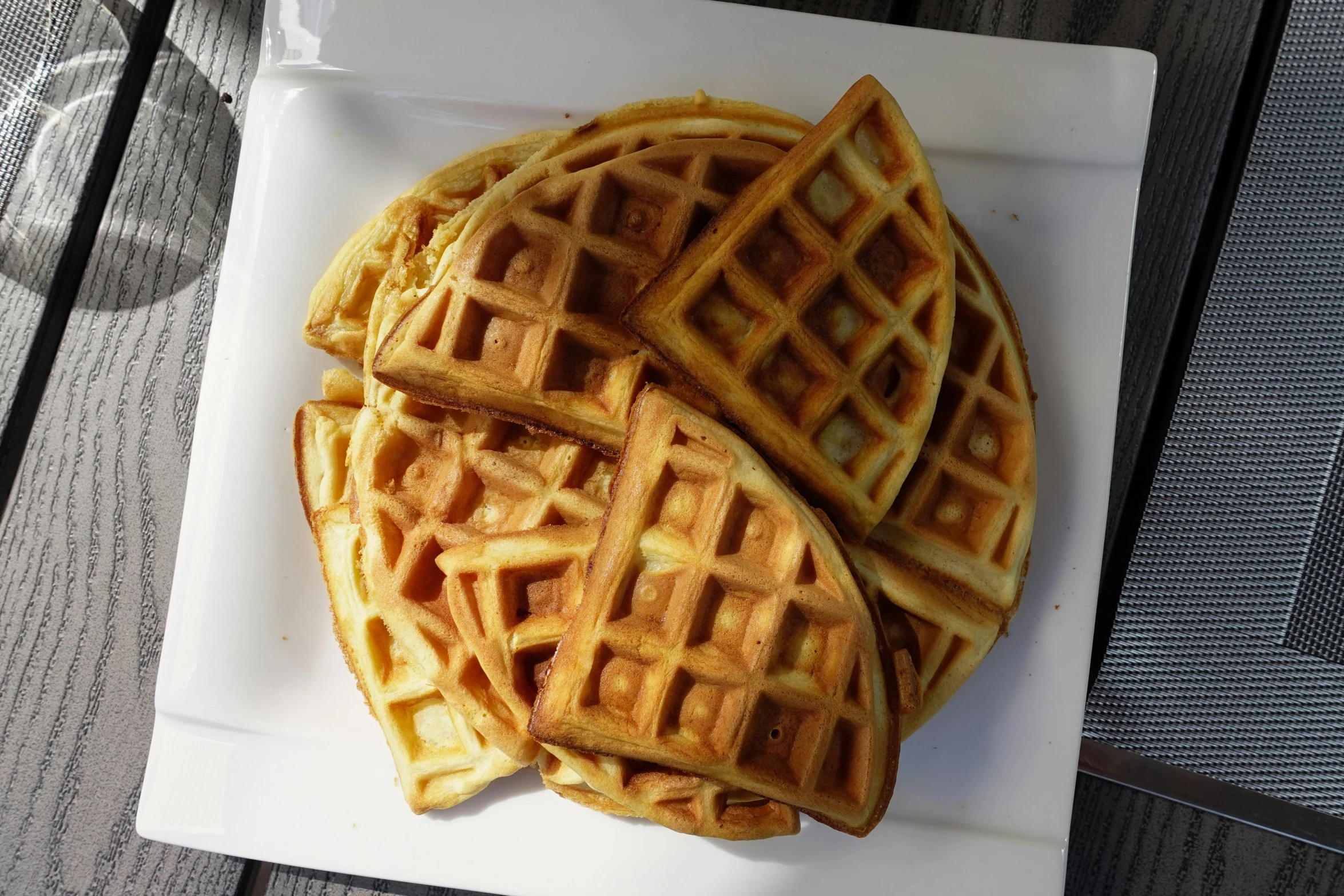 two waffles sitting on top of a white plate on a table