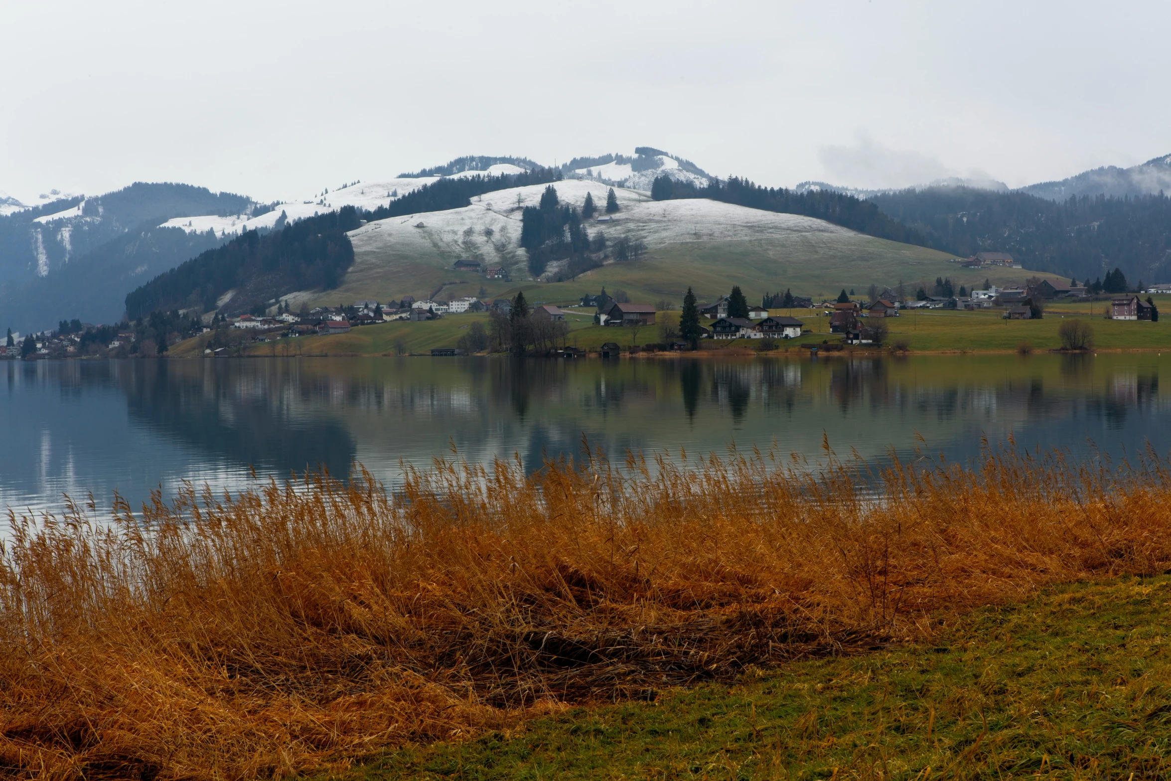 a beautiful lake surrounded by a lush green hillside