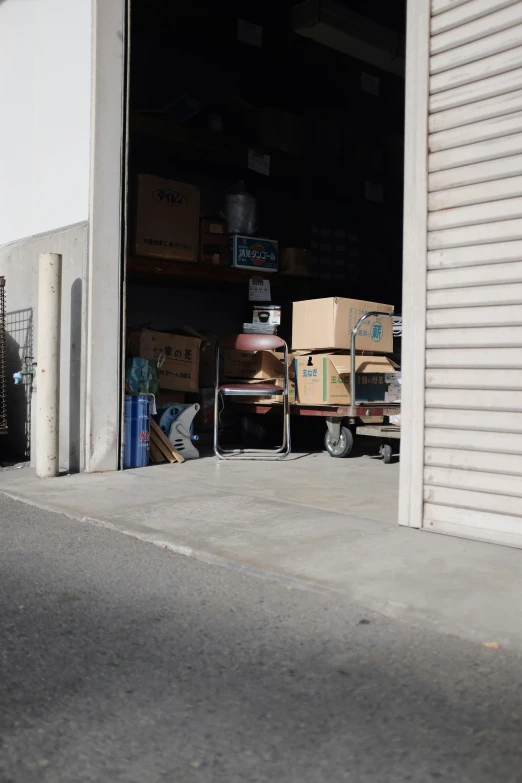 a bunch of boxes in a storage area with the door open