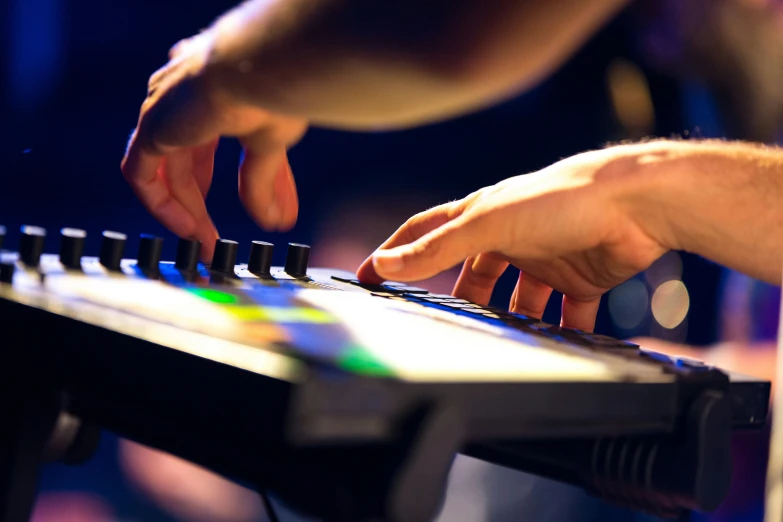 two hands on keyboard in a recording room