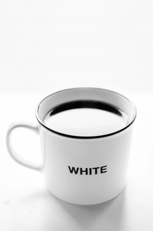 this white coffee cup has black writing on it