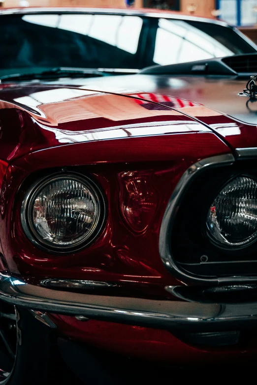 the front of an antique muscle car at a museum