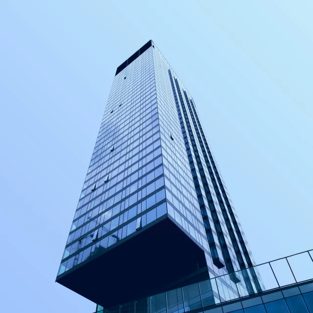 looking up at a modern building with glass