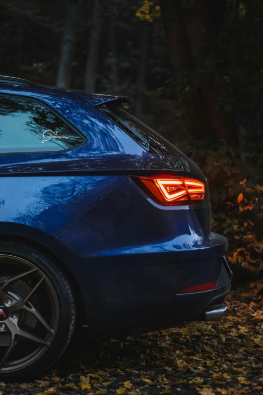 a blue car with the tail light on