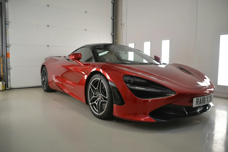 a red sports car in a car garage