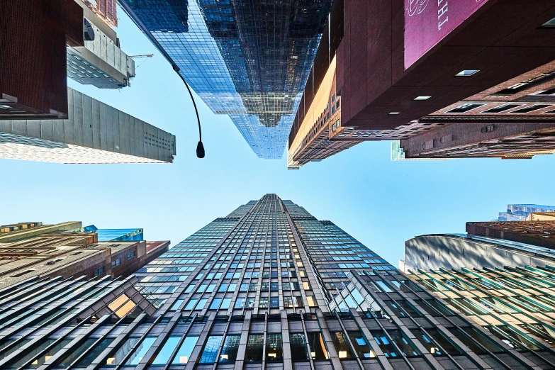 an upward view of buildings and sky scr