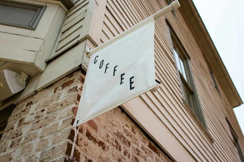 a banner is attached to a brick building