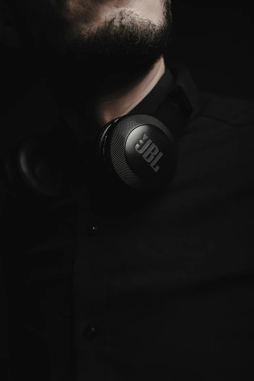 a man wearing a pair of headphones on his neck