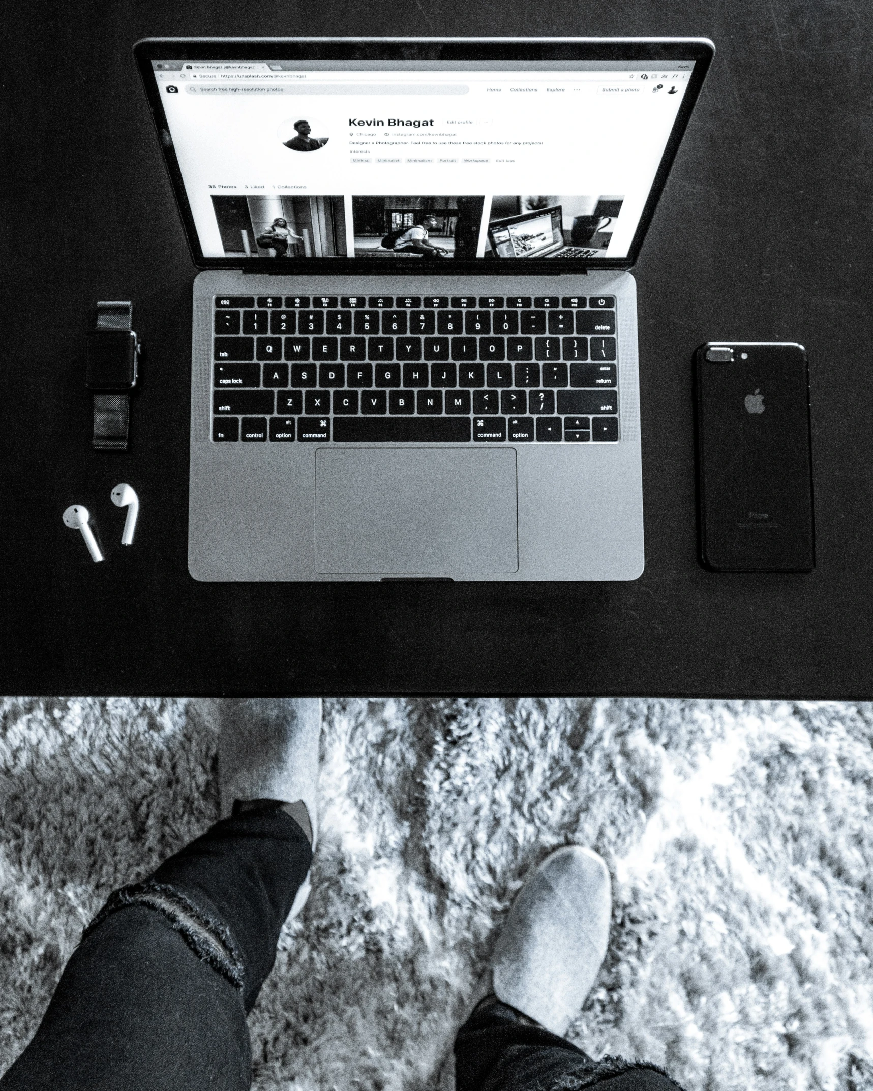 a person standing next to a laptop computer on top of a bed