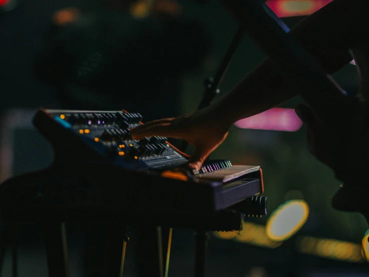 close up of a person playing on an electronic keyboard