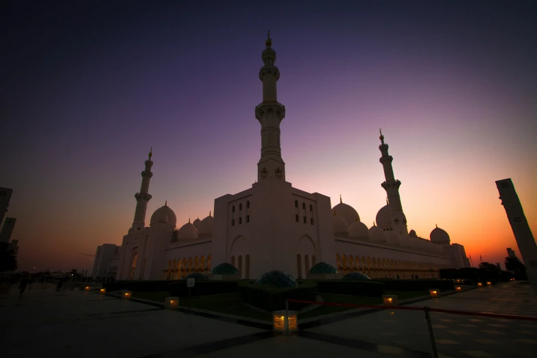 an outdoor s of the sunset over a mosque