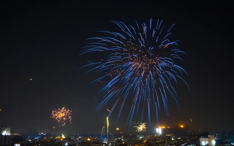 fireworks display in dark sky over city during night