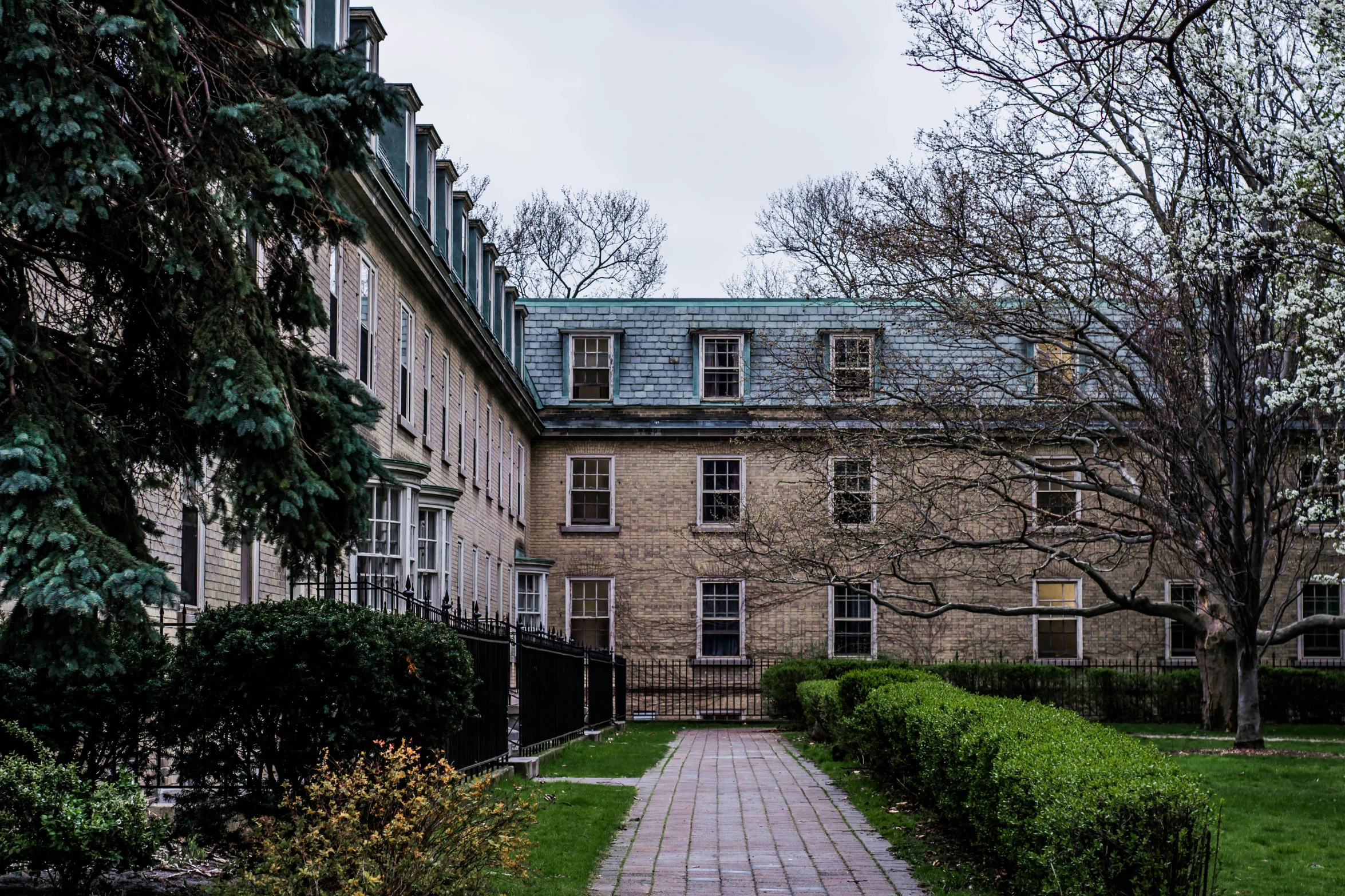 a brick walkway in the middle of a large house