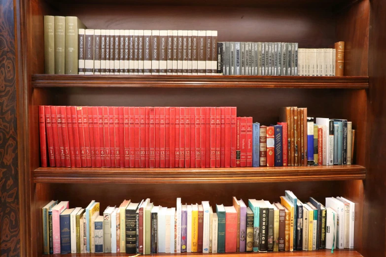 the bookshelf is holding many different types of books
