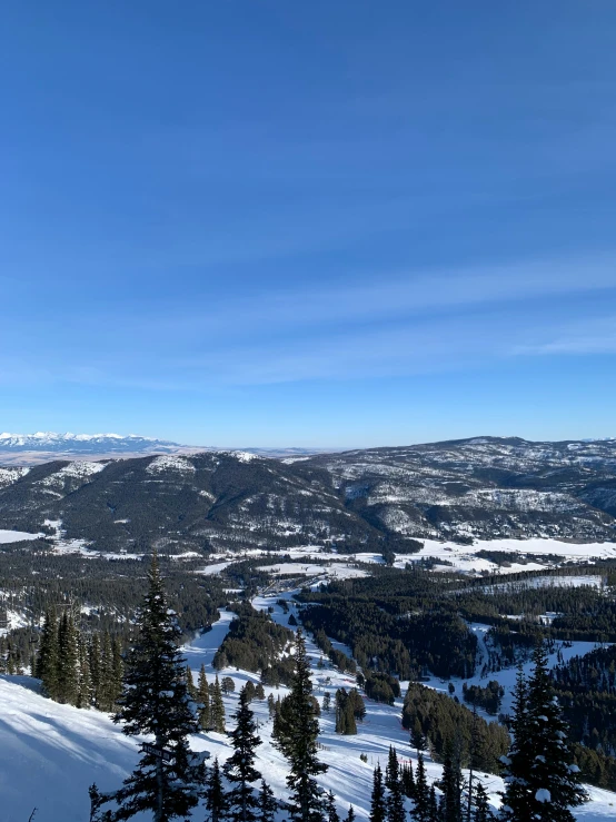 a couple of people skiing down a snowy mountain