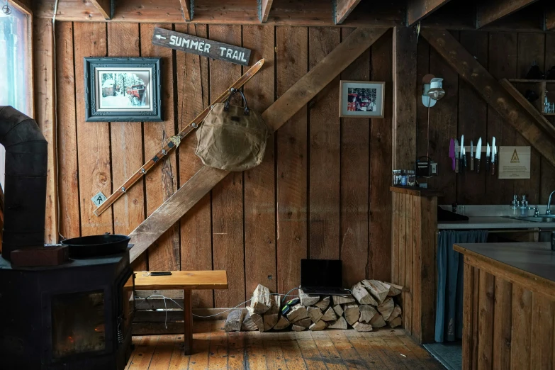 a rustic looking room with logs and a chair