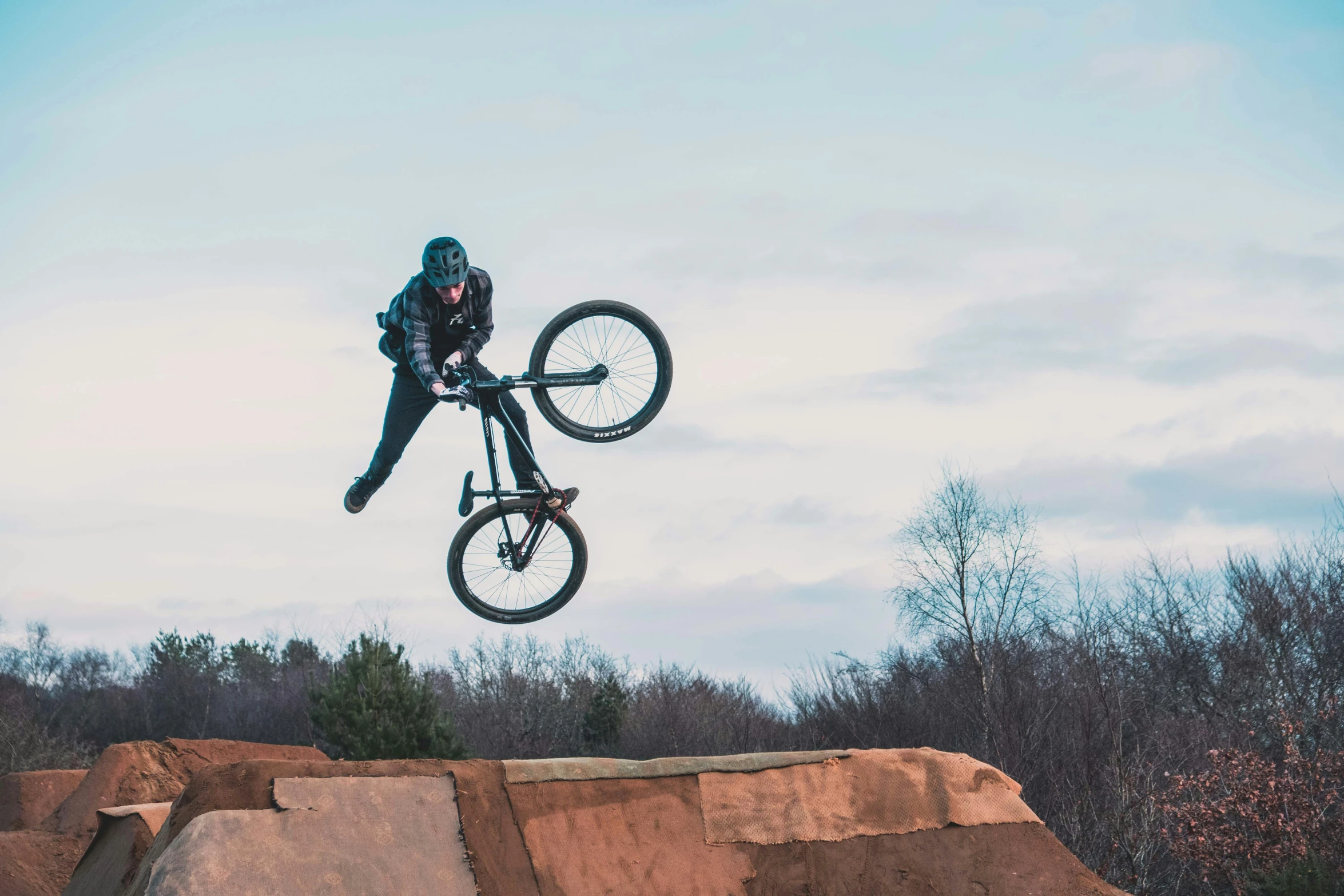 a man flying through the air while riding a bike