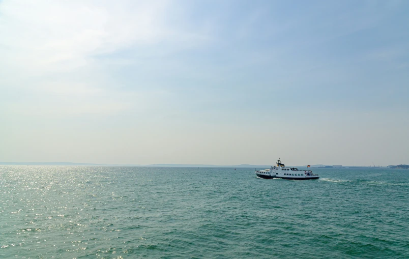 a boat on the water with the sky above