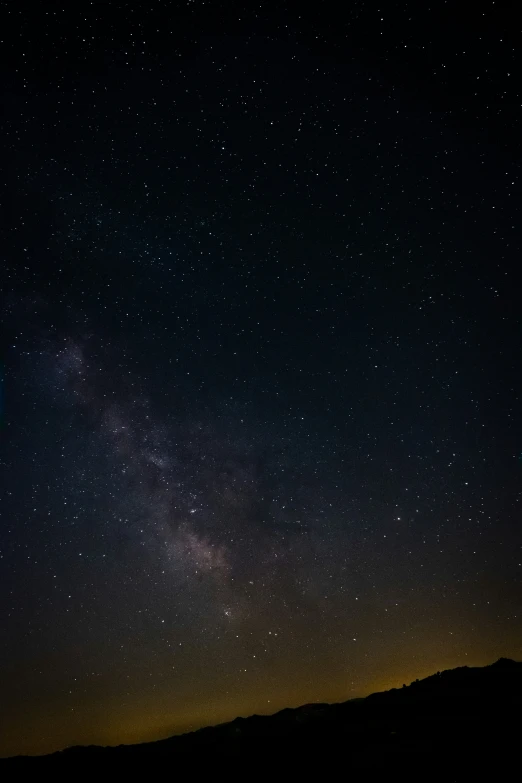 the night sky with some stars above it