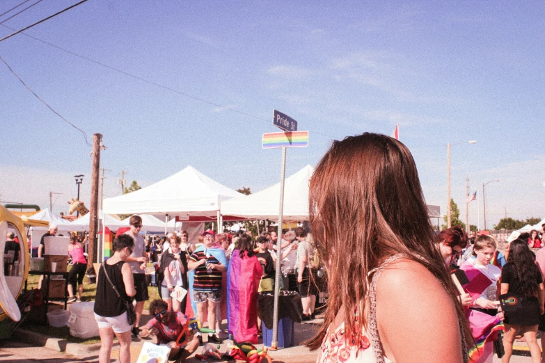 the woman is standing on her knees near tents at a fair