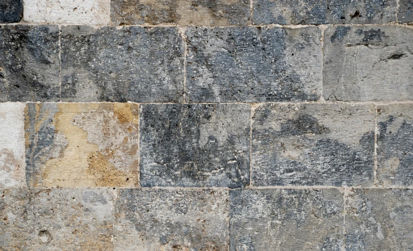 a large stone wall with different colors and textures