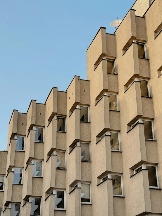 the side of a beige, two story building with multiple windows