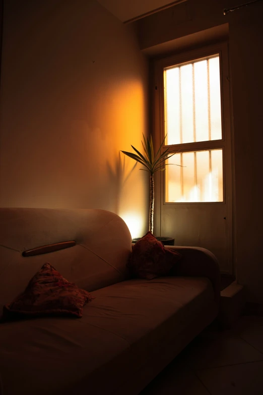a couch next to a window in a room