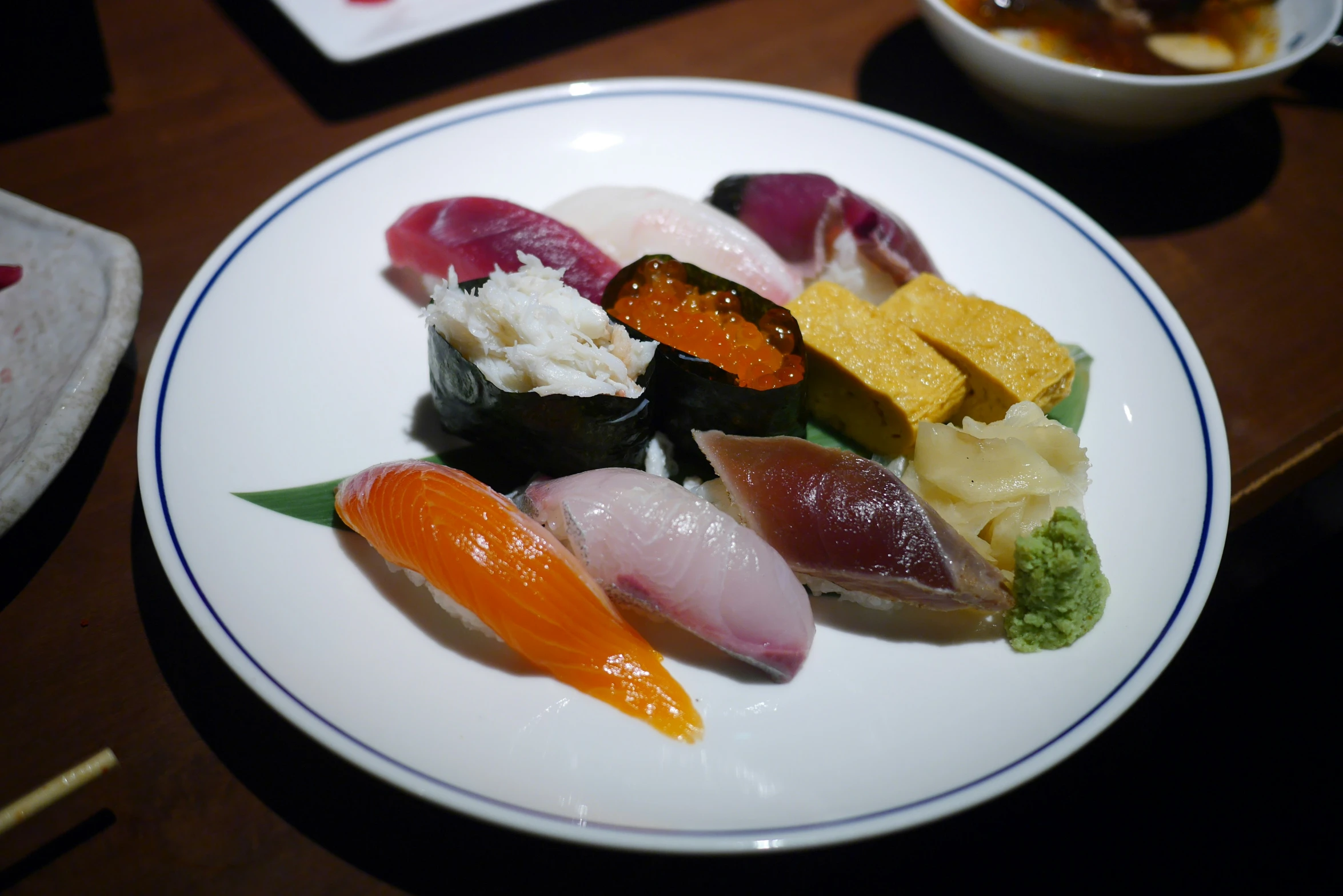 a plate with several different kinds of sushi on it