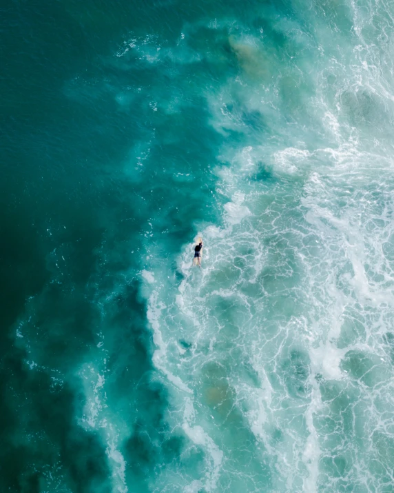 a person on a surfboard riding an ocean wave