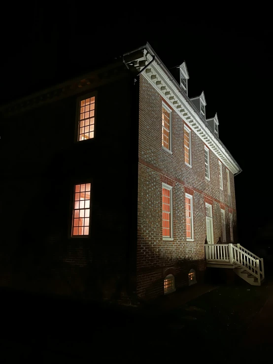 a large brick building with windows next to a night sky