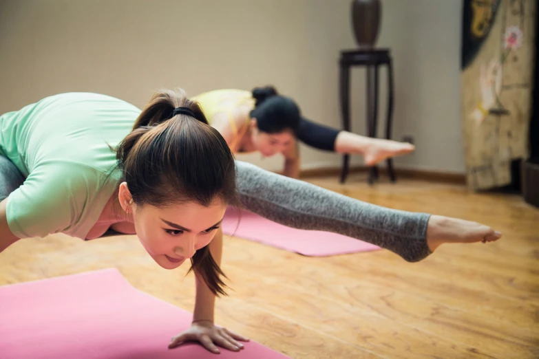 two people are doing yoga in a room