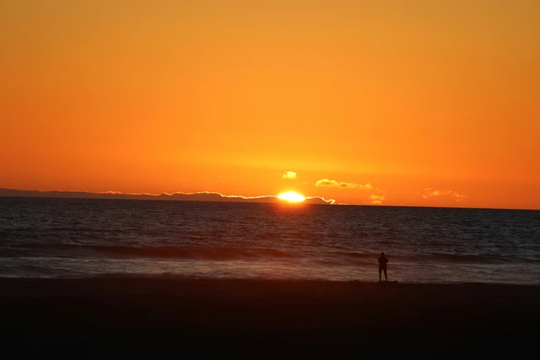 a man is at sunset at the beach