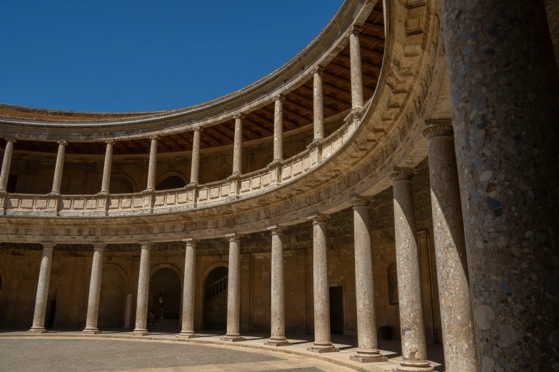 an old abandoned building with columns and arches