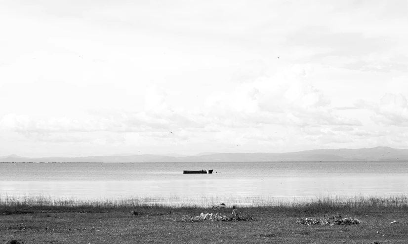 black and white po of the ocean with an old ship in it