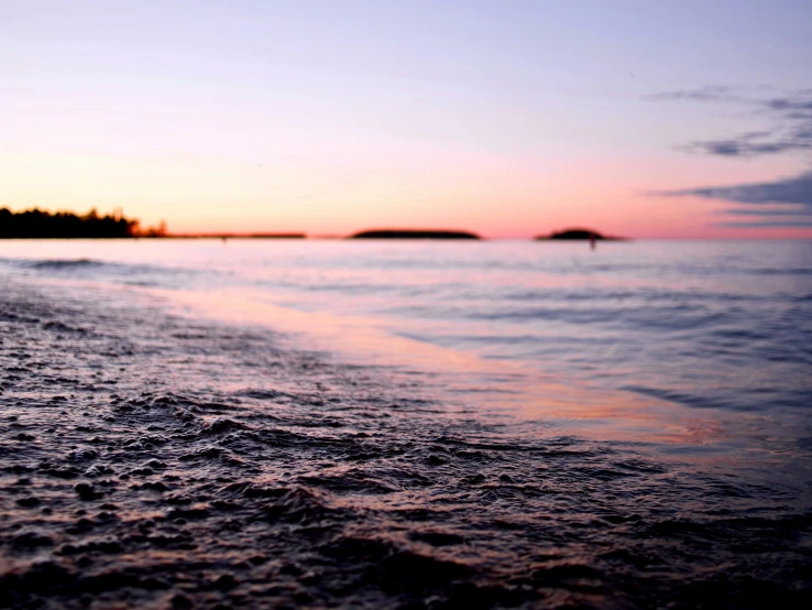 the sand beach is near the ocean and the land line