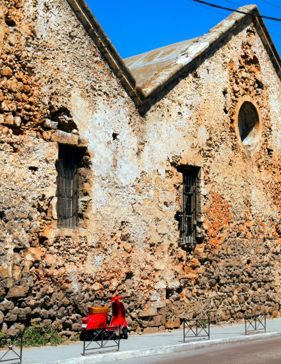 an old building with a car parked outside