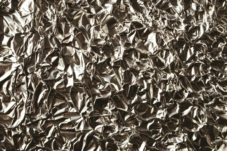 a silver surface is covered in lots of plastic wrappers