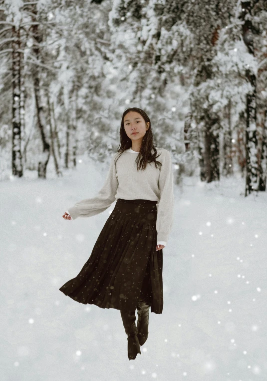 a woman in a white sweater and a dark brown skirt is flying through the air