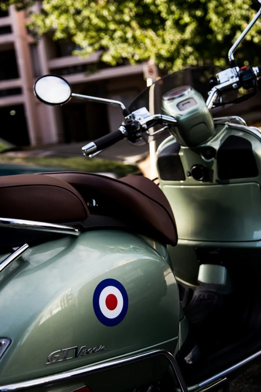 a green motorcycle parked next to a tall building