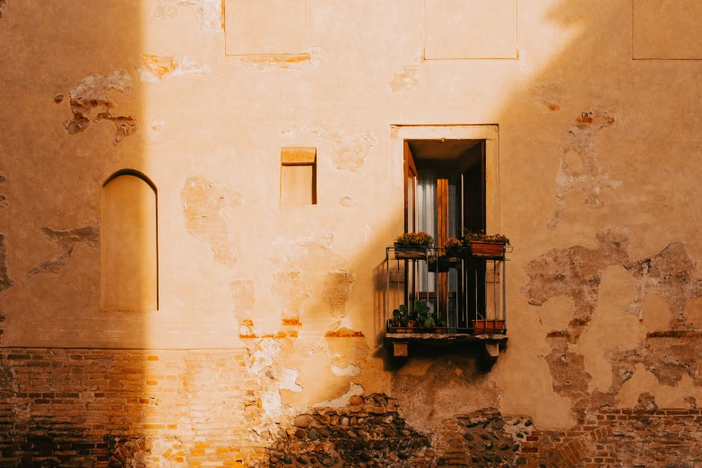 an outside view of an old looking building with the sun coming through